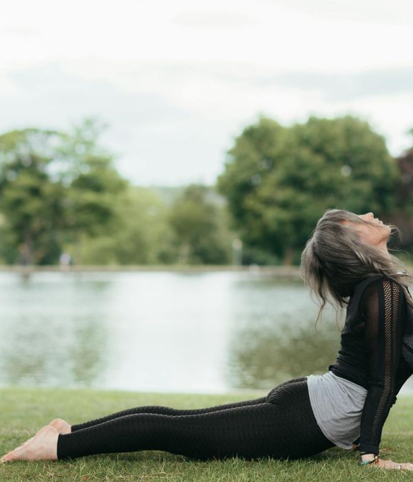Woman performing a serene yoga pose in a calm environment.